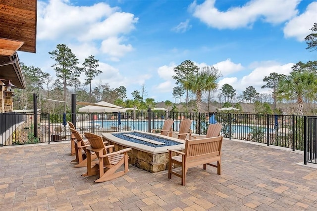 view of patio featuring a community pool and an outdoor fire pit