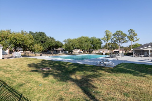 view of swimming pool featuring a lawn and a patio