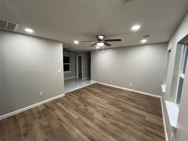 unfurnished room with ceiling fan and dark hardwood / wood-style floors