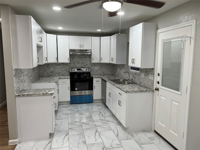 kitchen featuring sink, light stone counters, decorative backsplash, white cabinets, and appliances with stainless steel finishes