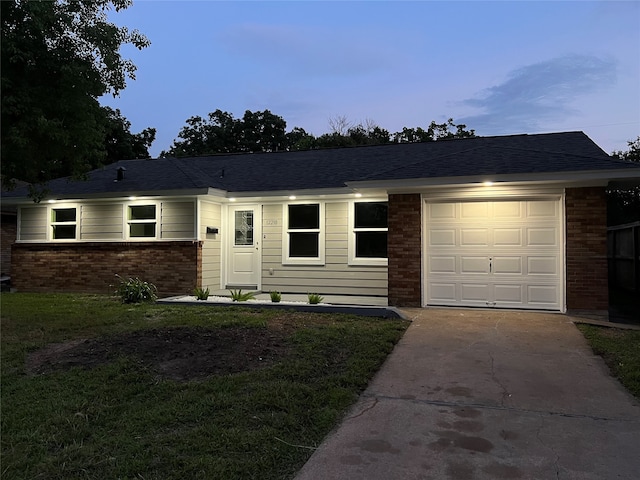 ranch-style home with a lawn and a garage