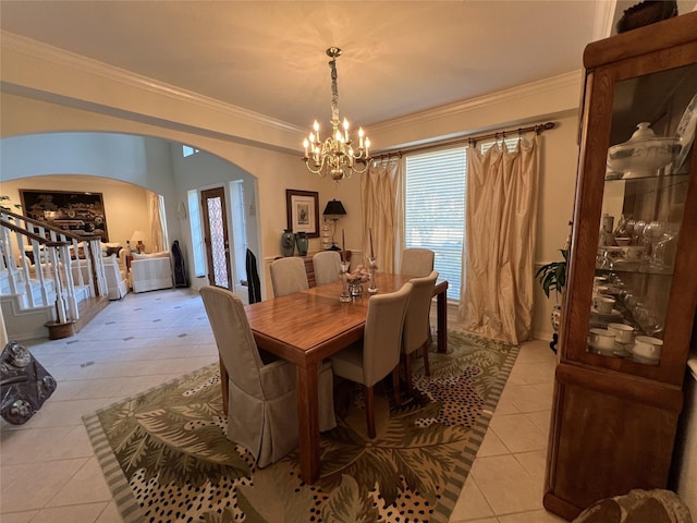 tiled dining area featuring an inviting chandelier and ornamental molding