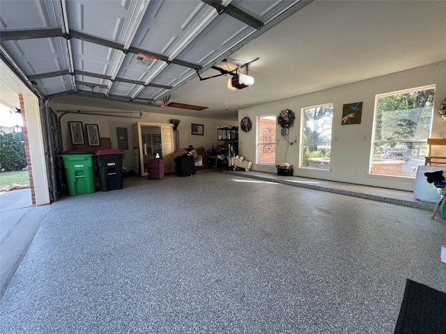 garage with electric panel and a garage door opener