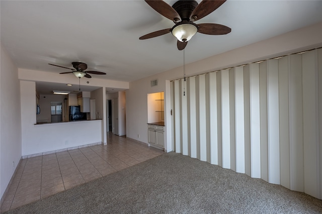 unfurnished living room with ceiling fan and light tile patterned flooring