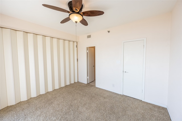 unfurnished bedroom with ceiling fan and light colored carpet