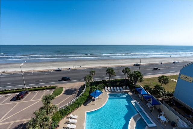 exterior space with a water view and a view of the beach