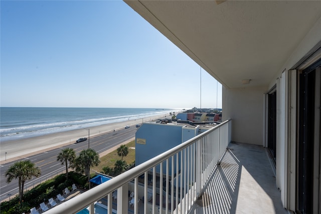 balcony with a view of the beach and a water view