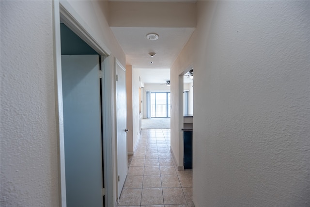 hallway featuring light tile patterned floors