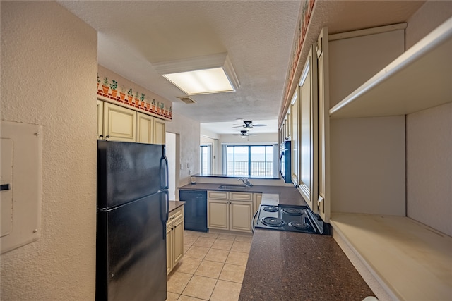 kitchen with ceiling fan, light tile patterned floors, sink, a textured ceiling, and black appliances