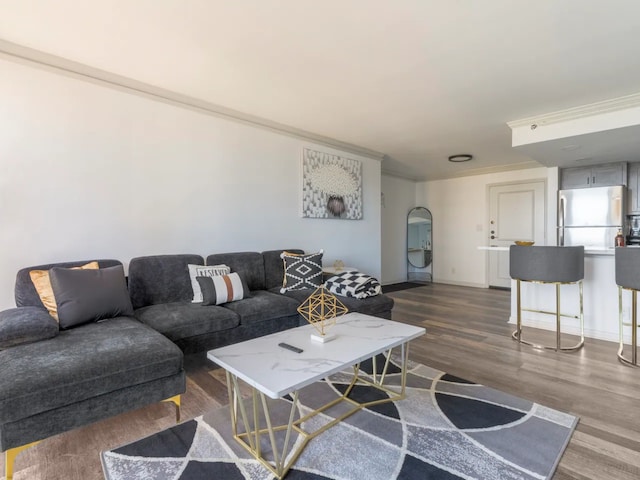 living room featuring dark hardwood / wood-style floors and ornamental molding