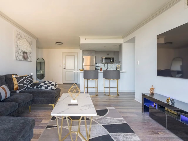 living room featuring ornamental molding and hardwood / wood-style floors