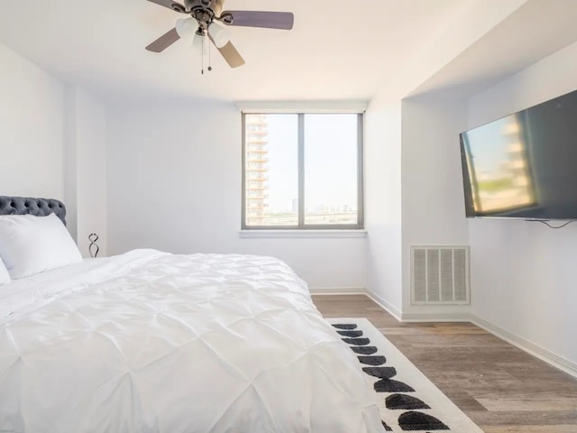 bedroom with light hardwood / wood-style floors and ceiling fan