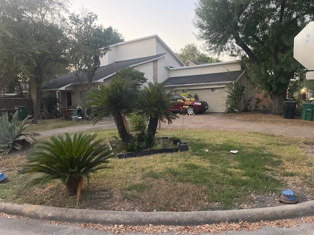 view of front of home with a garage and a front lawn