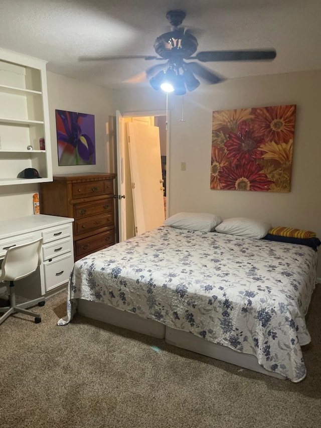 bedroom featuring ceiling fan and carpet