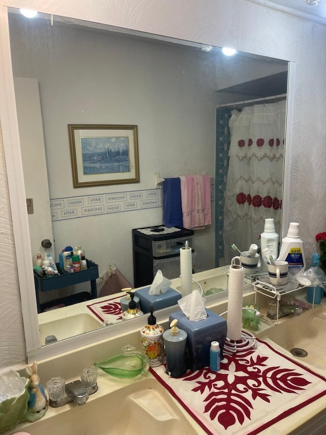 bathroom featuring walk in shower and vanity