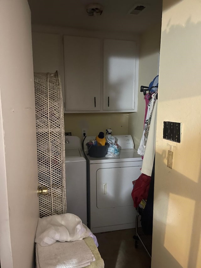 laundry room featuring separate washer and dryer, dark hardwood / wood-style floors, and cabinets