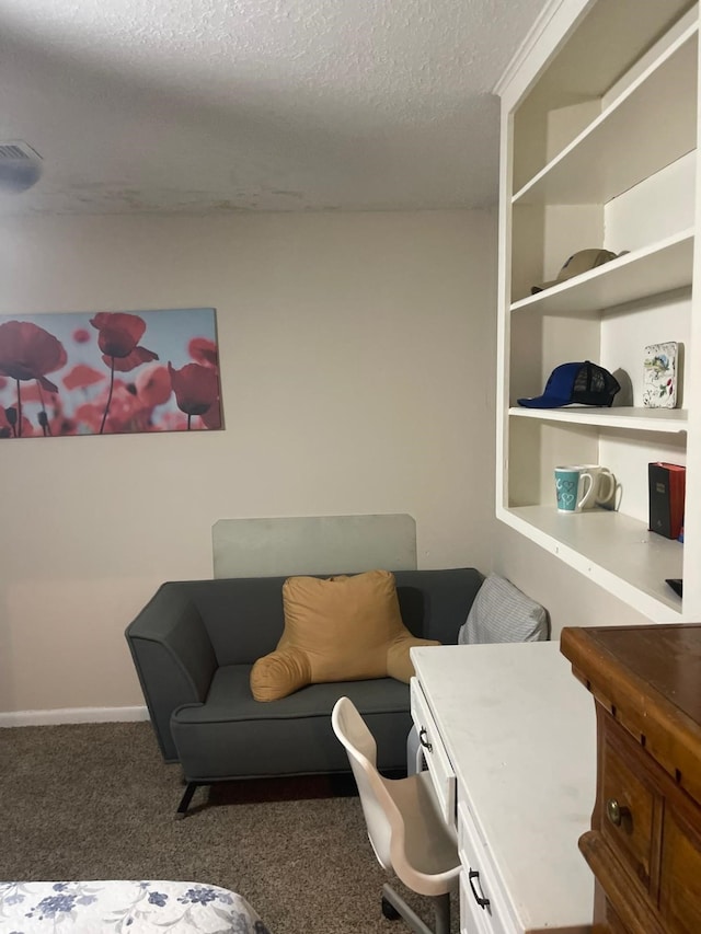 interior space with dark colored carpet and a textured ceiling