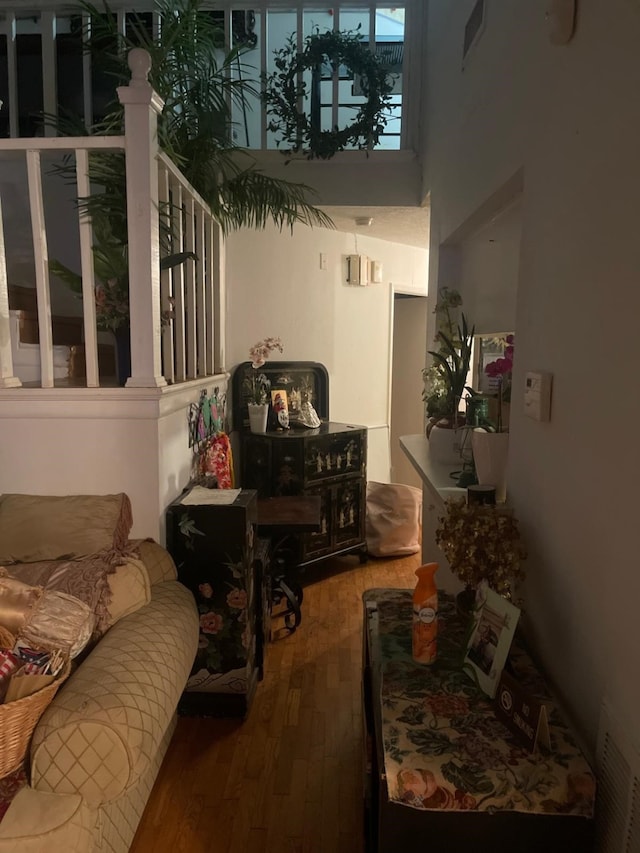 interior space with a high ceiling and hardwood / wood-style floors