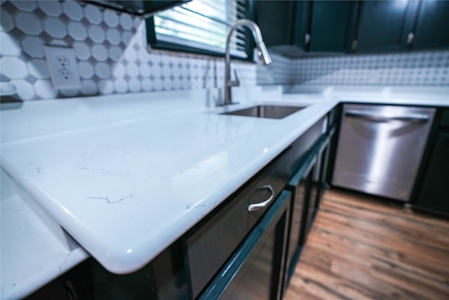 kitchen with dishwasher, sink, dark hardwood / wood-style flooring, and tasteful backsplash