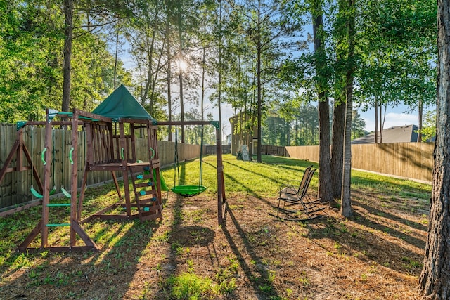 view of jungle gym featuring a fenced backyard and a yard