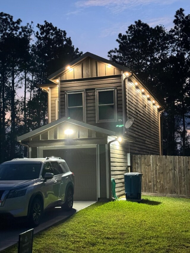 property exterior at dusk featuring a lawn and a garage