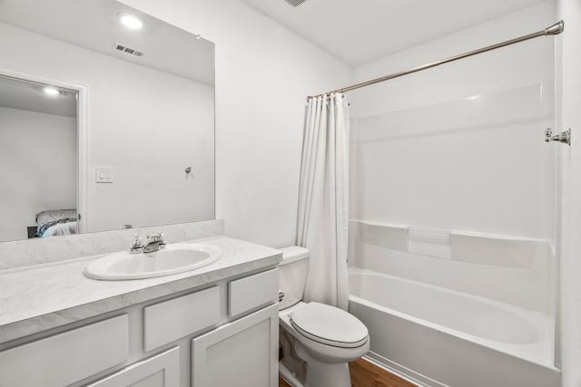 full bathroom with shower / tub combo with curtain, wood-type flooring, vanity, and toilet