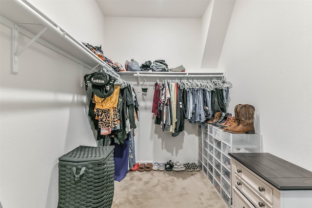 walk in closet featuring light carpet