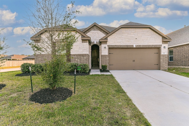 view of front of home featuring a front lawn and a garage