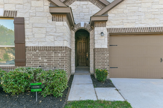 doorway to property with a garage