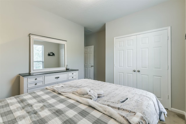 carpeted bedroom featuring a closet and a textured ceiling