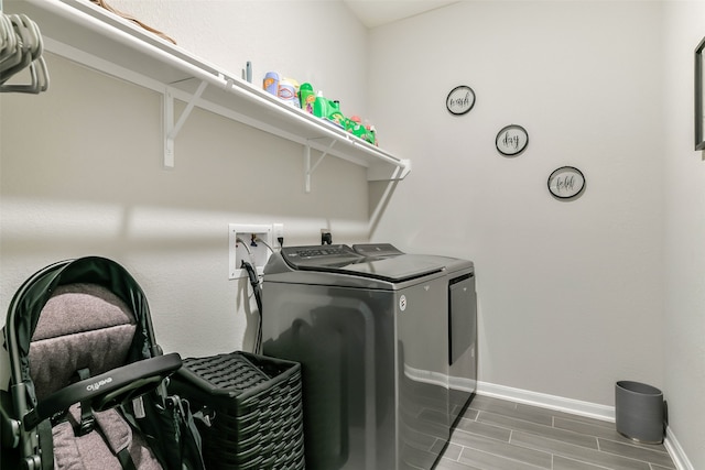 laundry area featuring wood-type flooring and independent washer and dryer