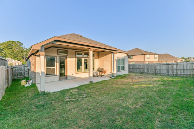 back of property featuring a yard and a patio