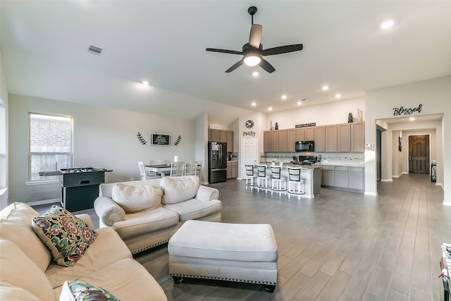 living room with ceiling fan and wood-type flooring