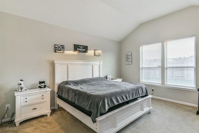 bedroom with light colored carpet and vaulted ceiling