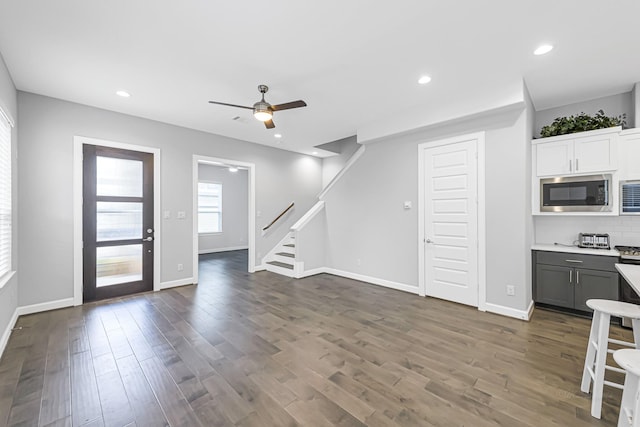 kitchen with built in microwave, dark wood-type flooring, white cabinetry, gray cabinets, and ceiling fan