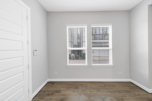 unfurnished room featuring dark wood-type flooring