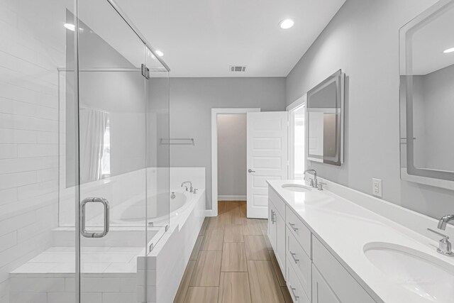 bathroom featuring vanity and plus walk in shower