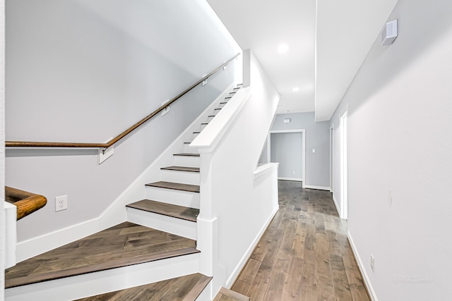 stairs featuring hardwood / wood-style flooring