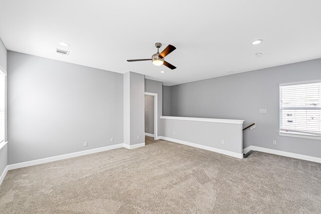 carpeted empty room featuring ceiling fan