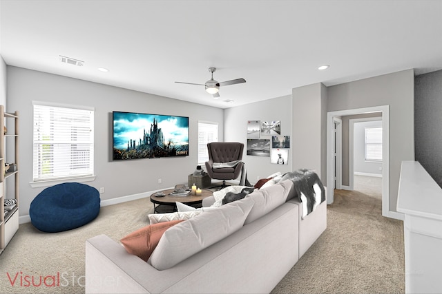 living room featuring light colored carpet and ceiling fan