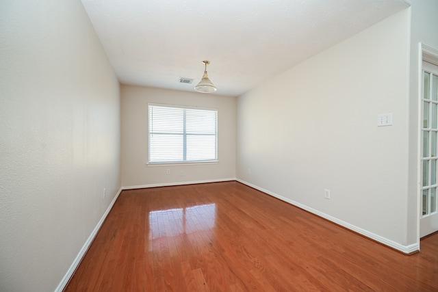 empty room with wood-type flooring