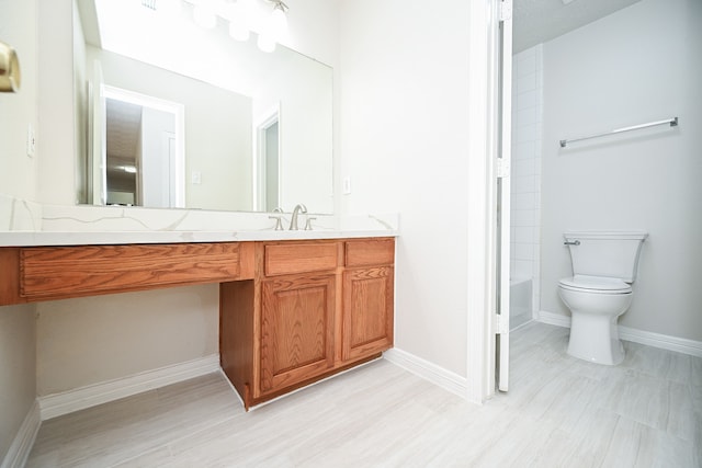 bathroom with hardwood / wood-style floors, vanity, and toilet