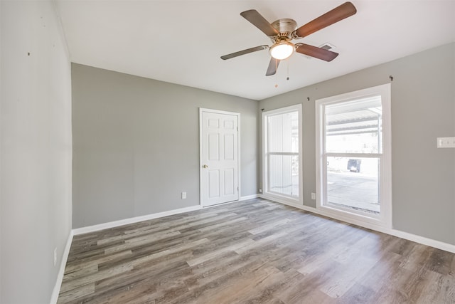 unfurnished room with wood-type flooring and ceiling fan