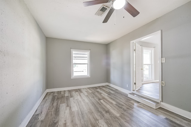 spare room featuring light hardwood / wood-style floors and ceiling fan