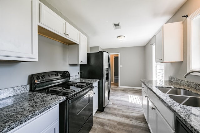 kitchen featuring light hardwood / wood-style floors, white cabinetry, sink, and stainless steel appliances