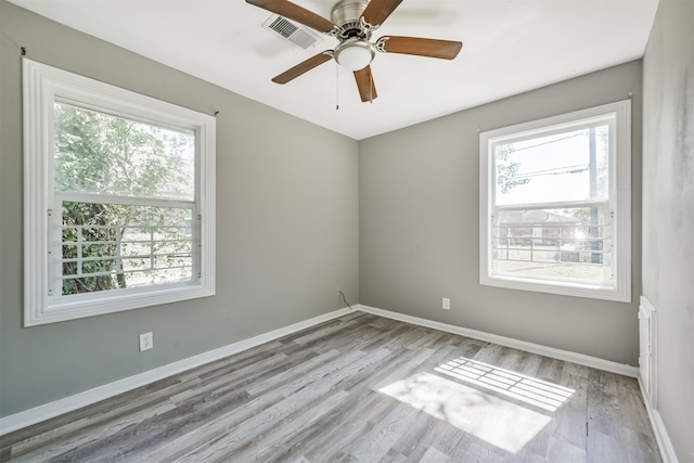 unfurnished room featuring light wood-type flooring, a healthy amount of sunlight, and ceiling fan