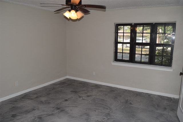 empty room featuring ceiling fan and a textured ceiling