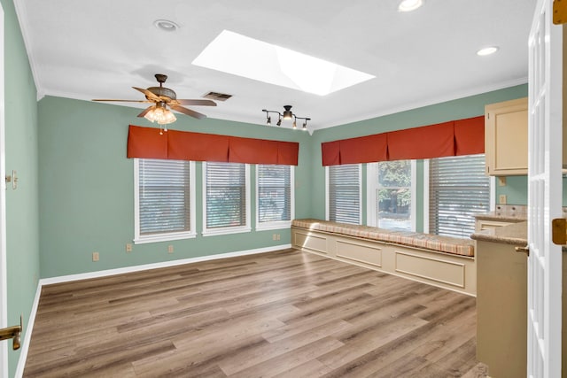 interior space with ceiling fan and a skylight