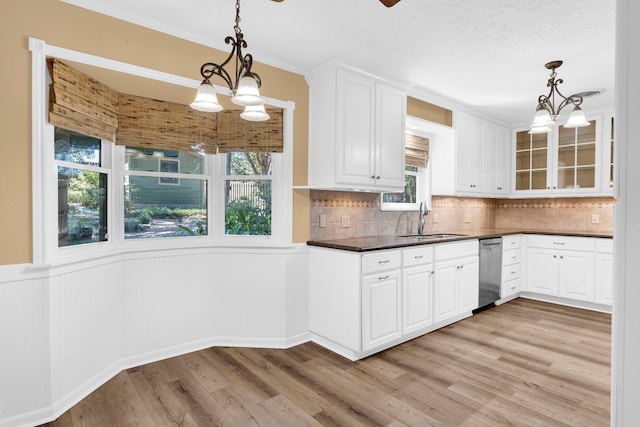 kitchen with light wood-type flooring, hanging light fixtures, sink, and an inviting chandelier