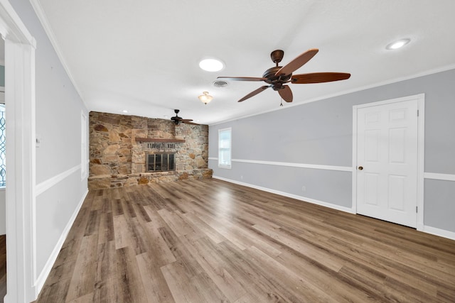 unfurnished living room featuring a fireplace, ornamental molding, hardwood / wood-style floors, and ceiling fan